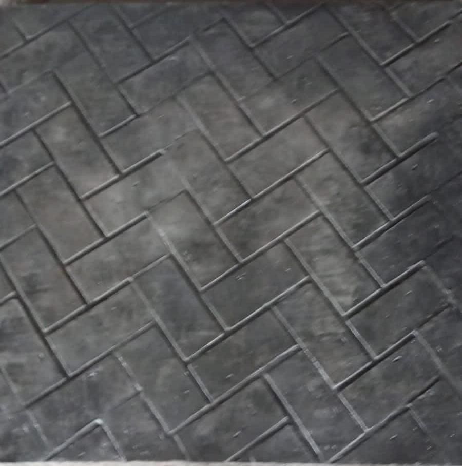 Dark grey stamped concrete with herringbone pattern